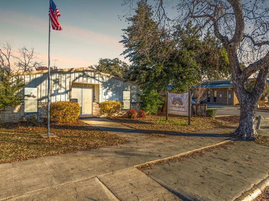 219 E Elm listing photo, one-story metal office now Little Learners
