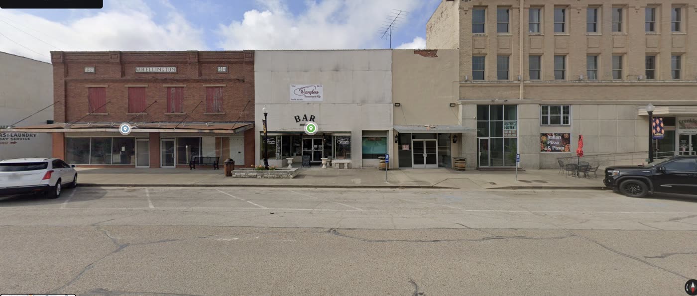 South side of East Elm: Johnson Cleaners, Wrangler’s, and Frenkie’s